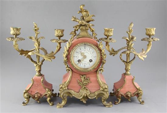 An early 20th century French pink marble clock garniture, 13.5in.